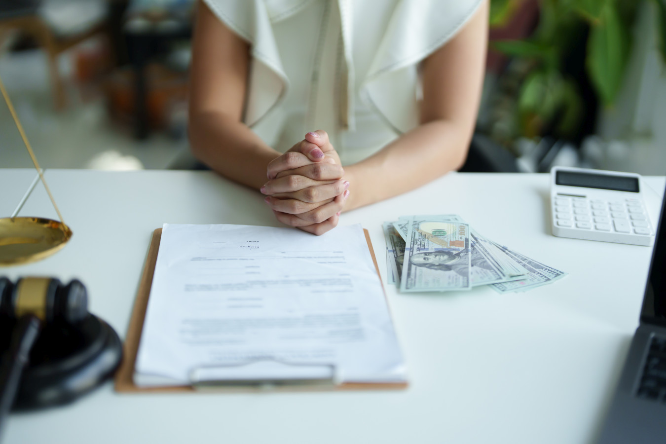 Law and legitimacy, woman holding hands expressing concern during litigation consultation with lawyer Law and legitimacy, woman holding hands expressing concern during litigation consultation with lawyer.